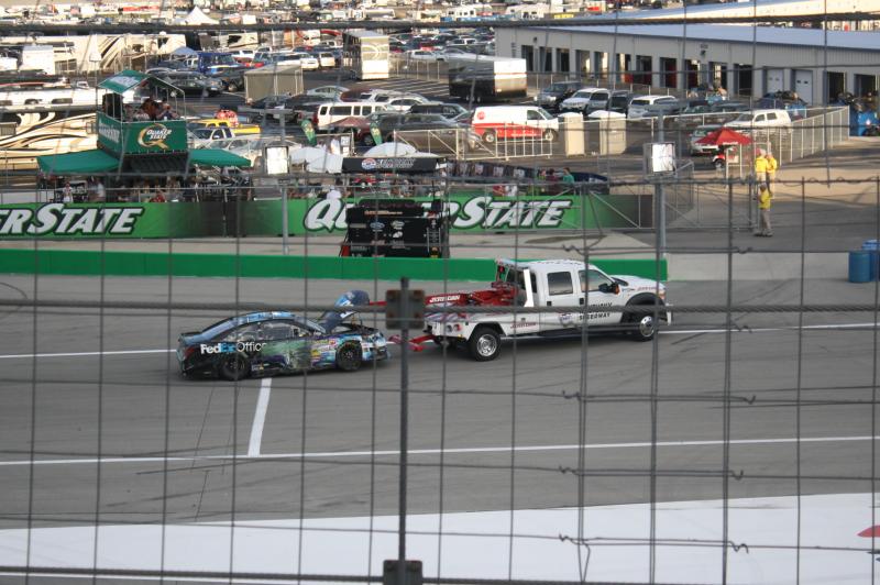 Denny Hamlin's #11 FedEx Toyota Camry being towed away as he hit the turn 4 wall during the 11th lap of the race.
Quaker State 400.
Sparta, Kentucky. 