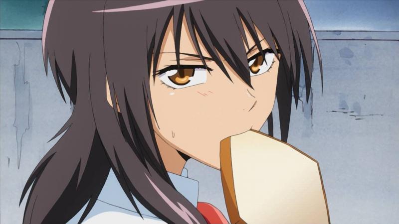 Some cute girl eating bread.