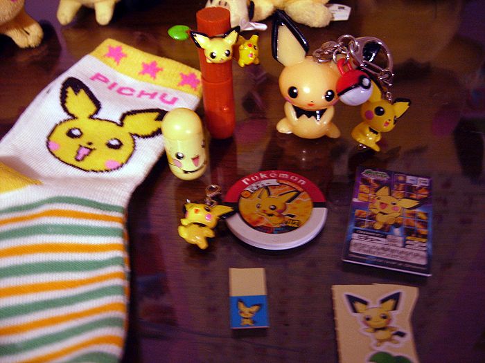 This is my misc Pichu stuff. There are Pichu socks... which are too small for me, a few keychains, a mighty beans thing, disc, stickers, Pichu and Pik